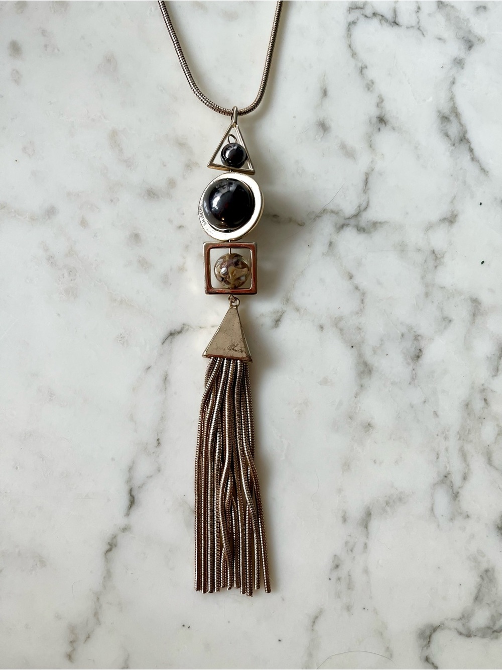 Abstract long pendant statement necklace with marbles and tassel in gold tone